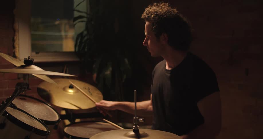 A man sitting and playing the drums