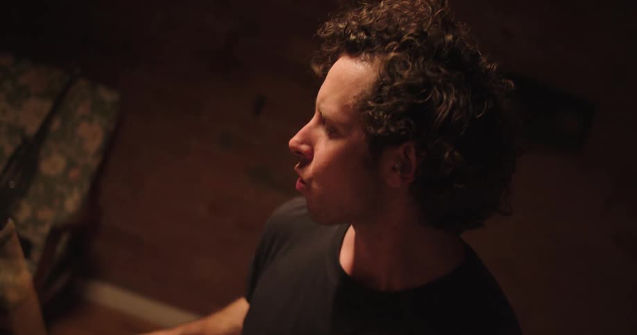 A man playing the drums indoors