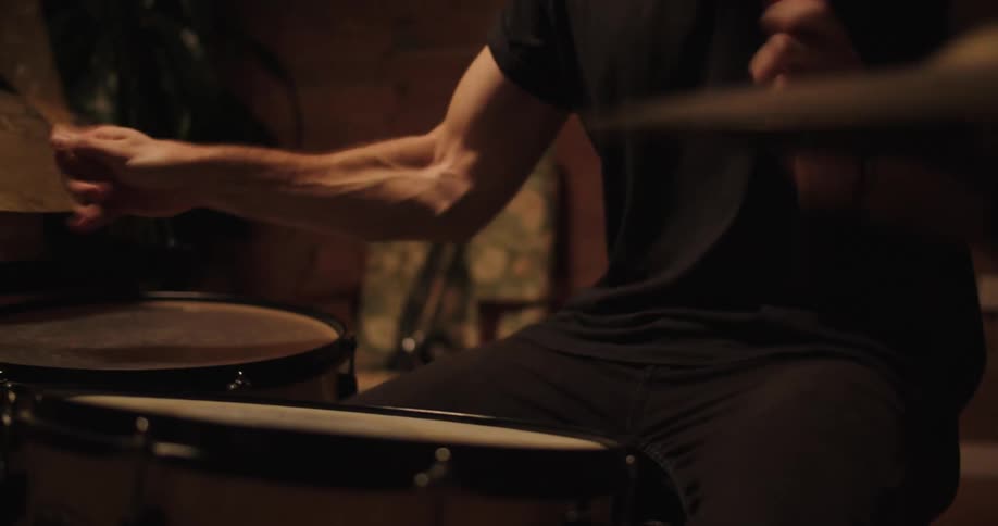 A man drums hard