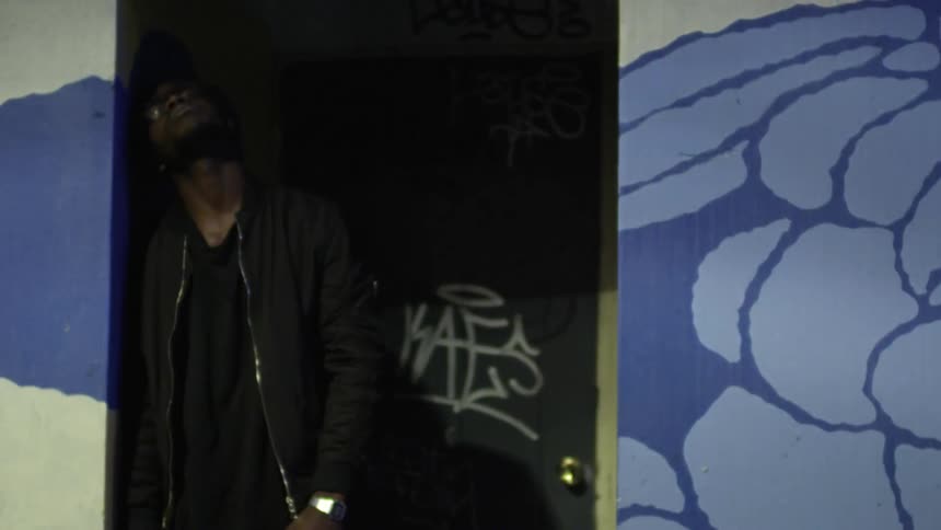 Depressed man leans against a wall