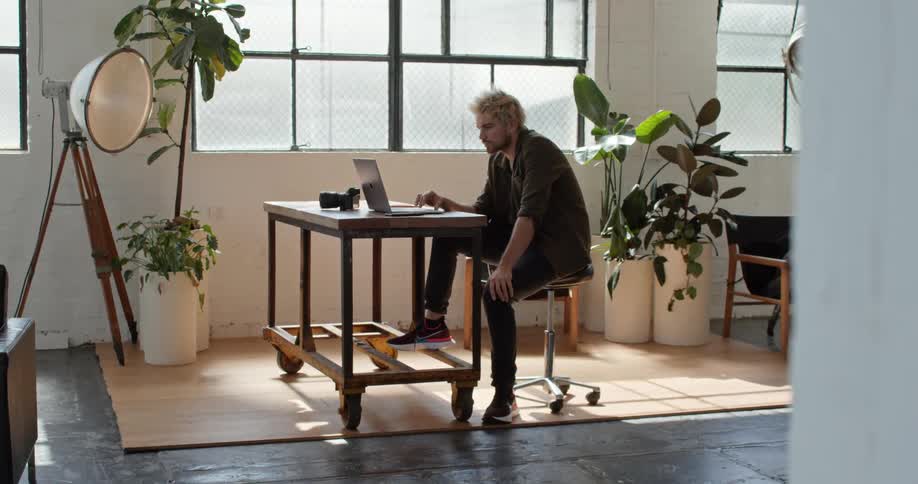 A man works on his laptop in his office