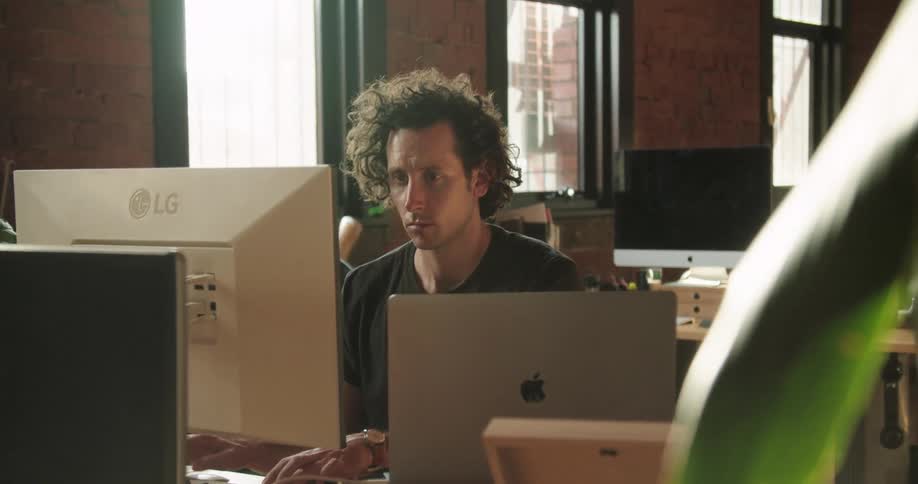 A man is typing on a keyboard in the office