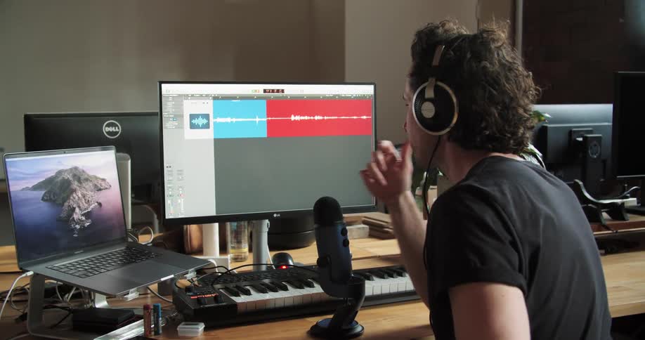 A man records his voice into a computer