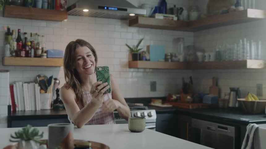 A woman chats on her phone