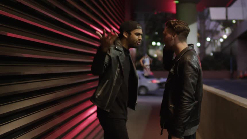 Two men having a heated discussion in an urban area
