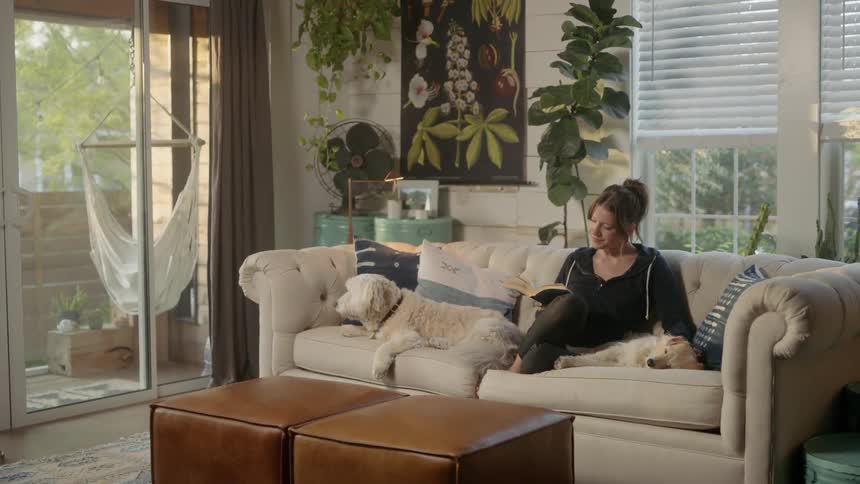 A woman reads on the couch