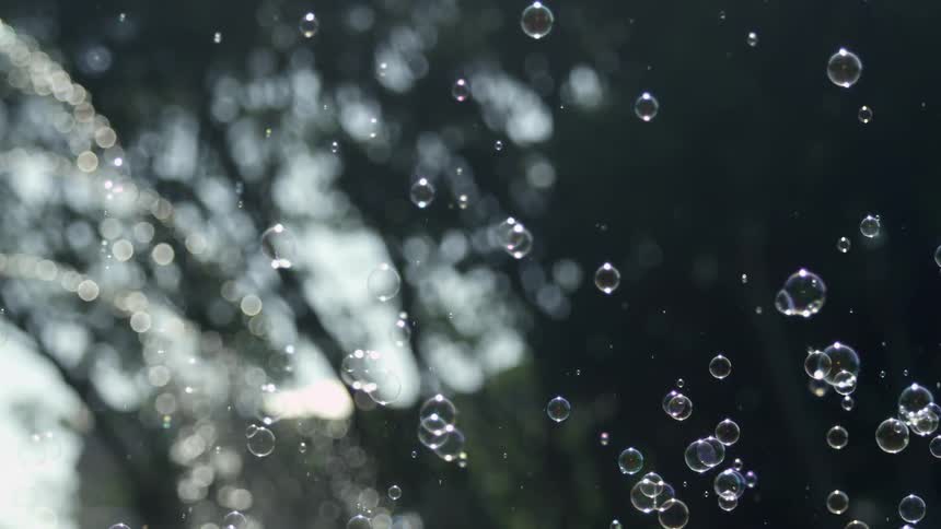 Water is spraying from a fountain and causing bubbles