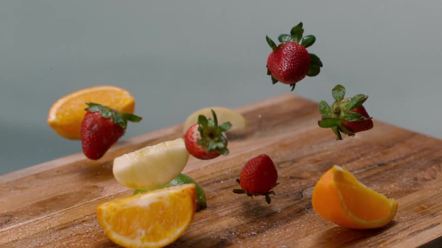 Fresh fruit drops to a table