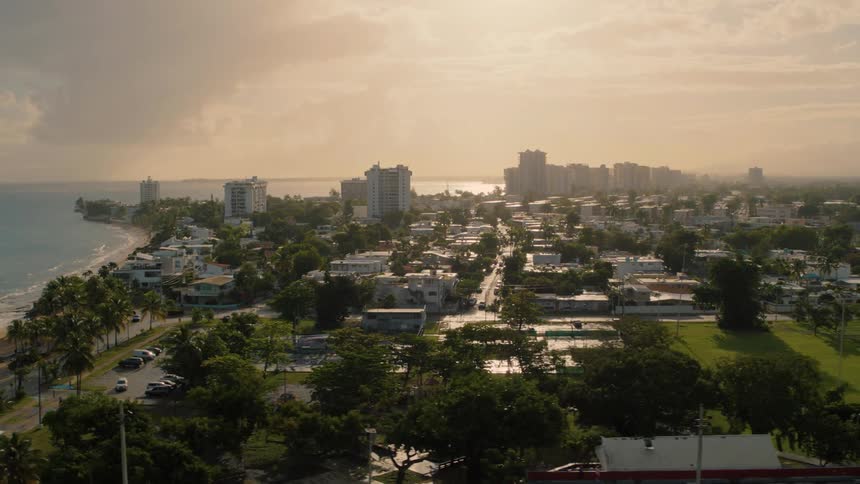 A coastal city close to the beach with buildings and trees