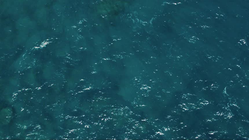 The sun reflects off the ocean below