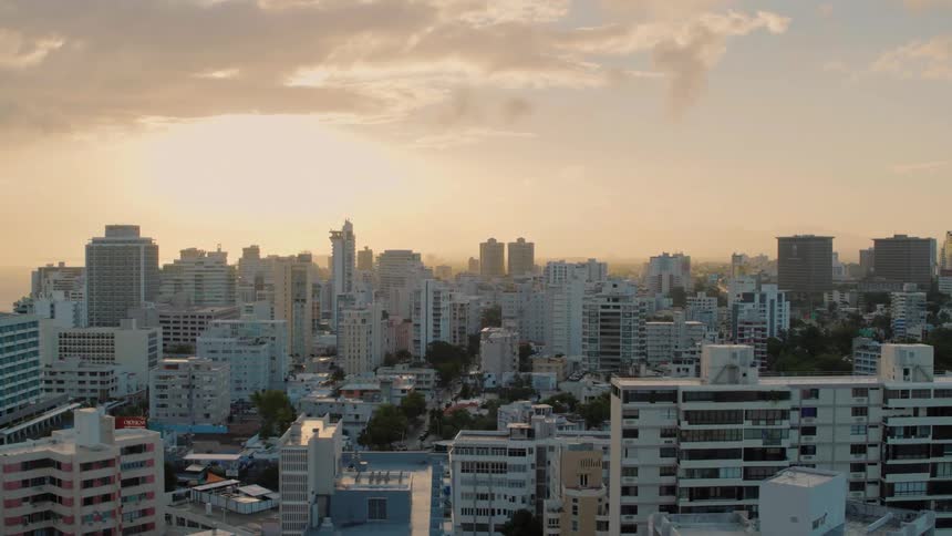 Flying over a city at sunset