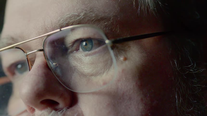 A man is looking at a monitor