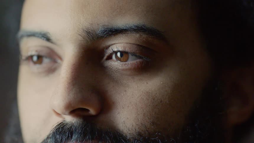 A man looking off into the distance with light shining on his face