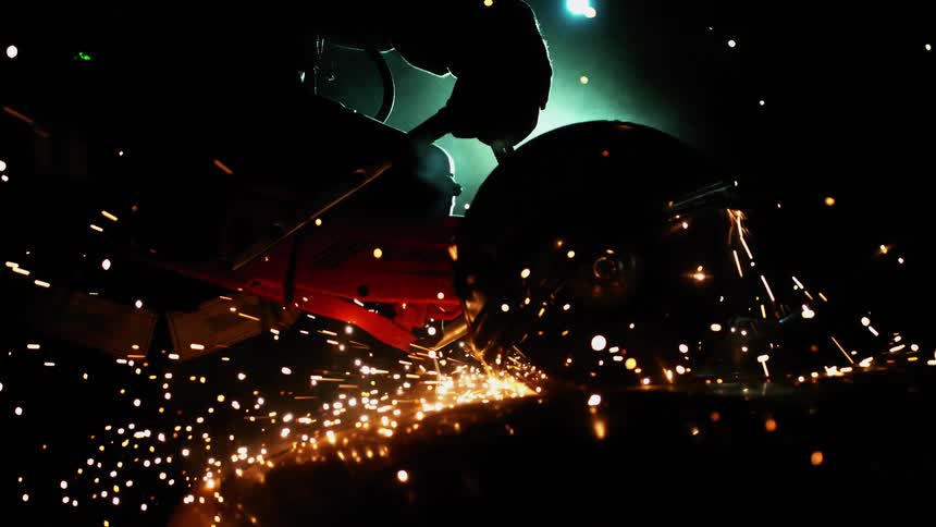 Silhouette of circular saw in use with sparks flying