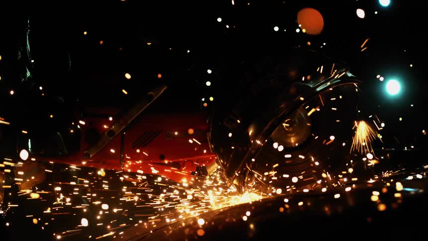 Sparks fly as a saw blade touches metal