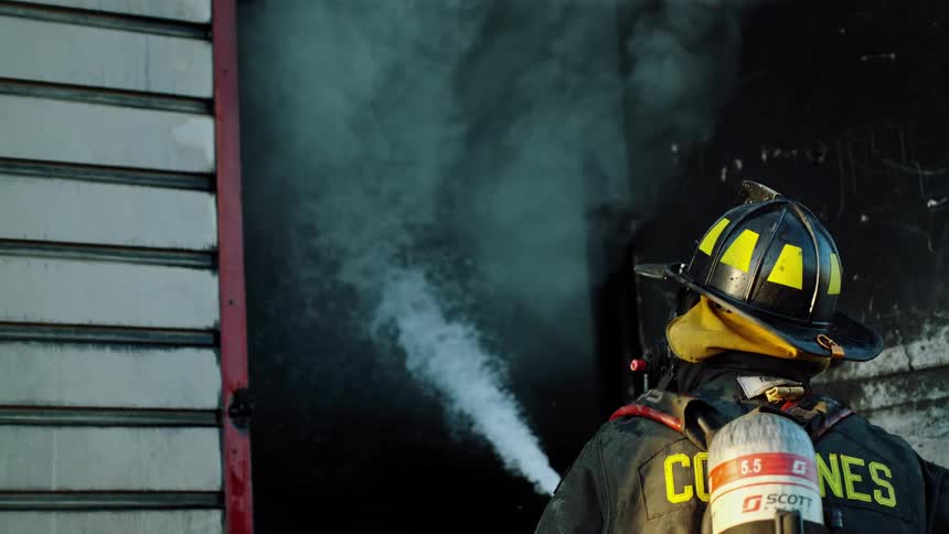 A firefighter uses the hose