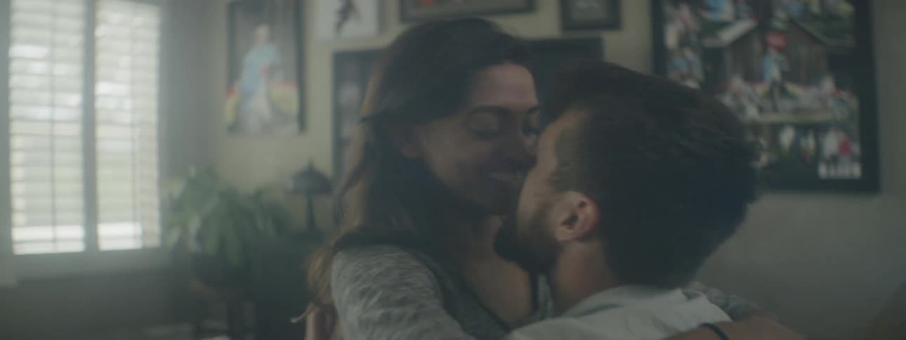 A man and a woman hugging and kissing