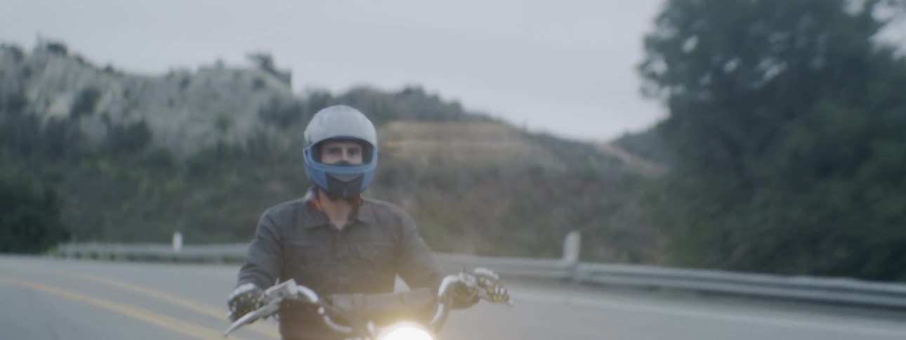 A man rides a motorcycle
