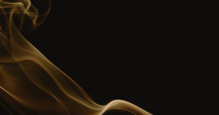 Wisps of smoke gently billow upwards against a dark background