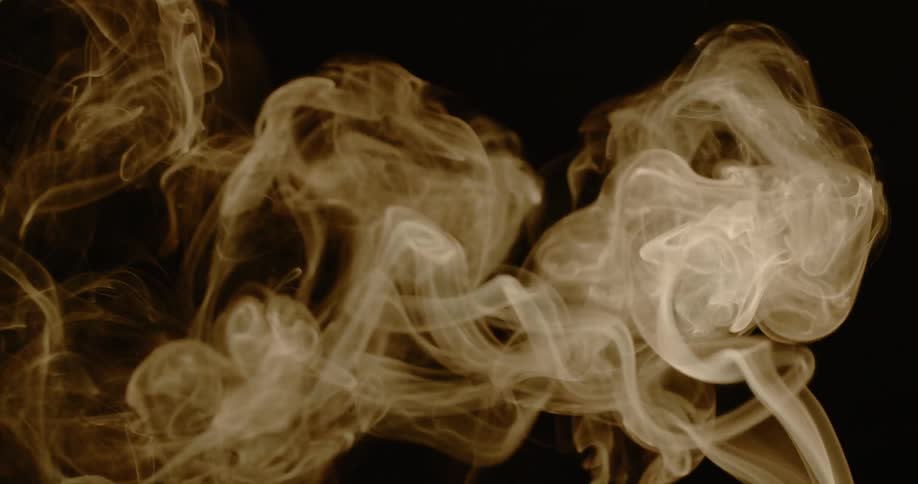 Smoke floats upwards in the dark