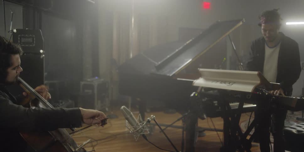 Two men jam together in a recording studio