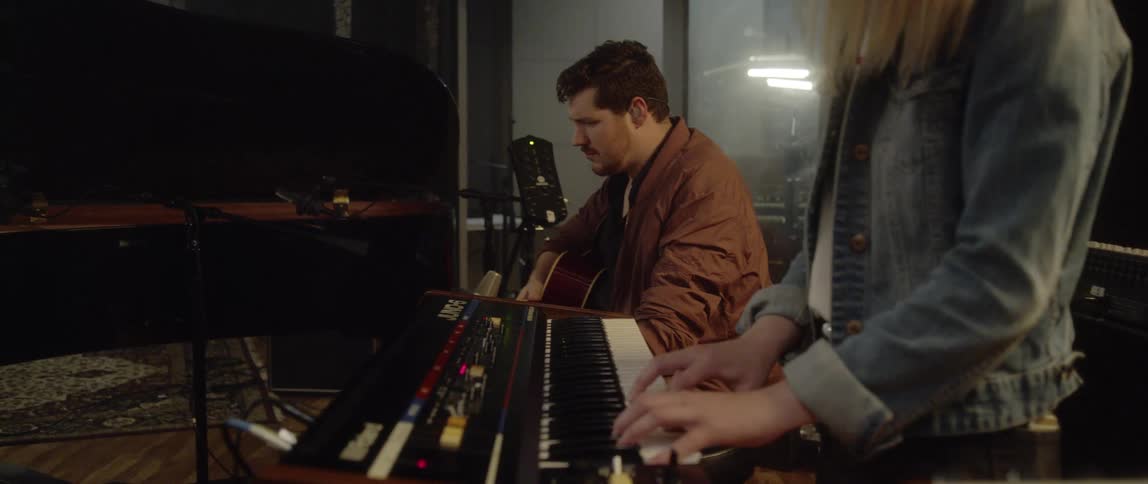 Three musicians play instruments in a band