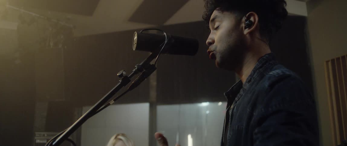 A man sings into a microphone