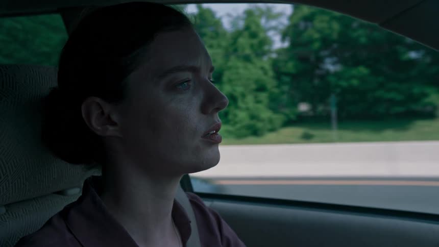 A woman talks to herself while driving along the highway