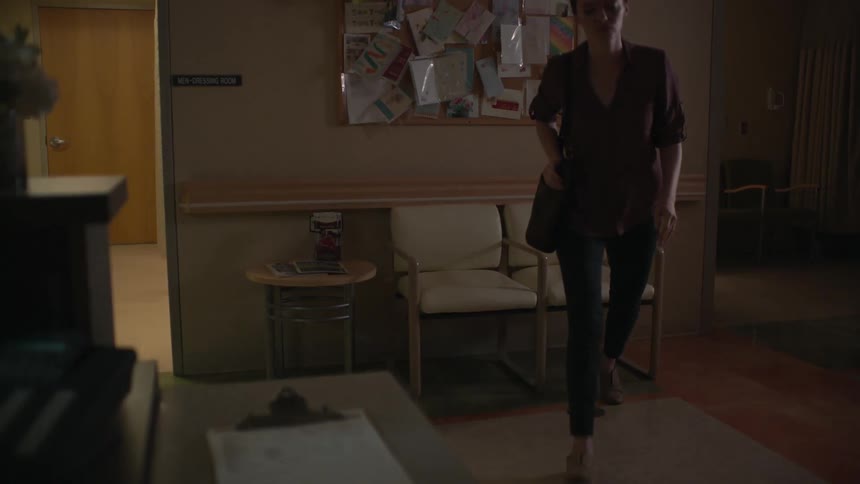 A woman stands to walk