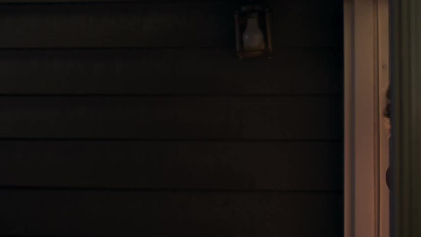 Man standing at the entrance of the door turns his head and gets inside