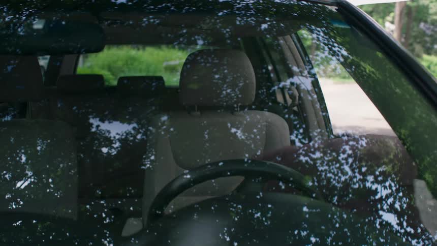 A woman gets out of her vehicle