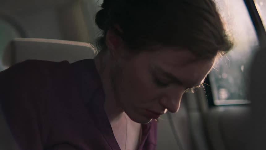 Woman sleeping in the car gets up and looks around anxiously