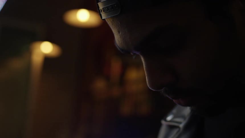 A man looks down inside a brightly lit building