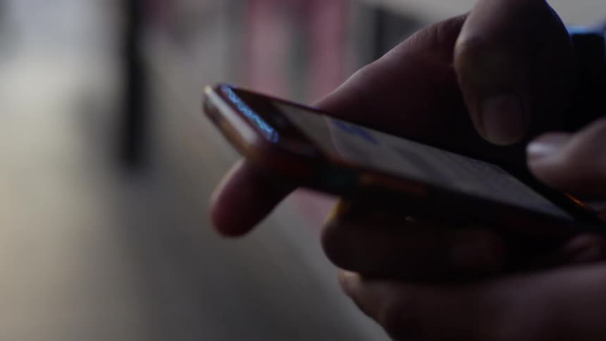 A person types on a smartphone