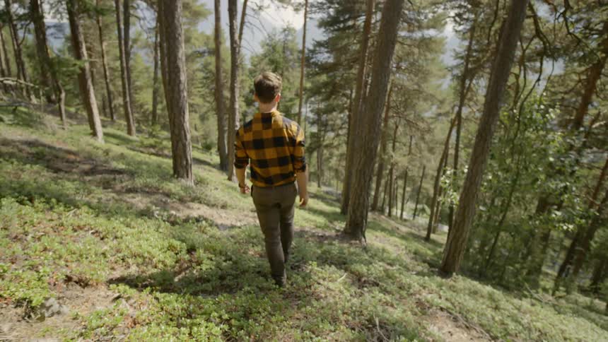 Man goes downhill in the forest