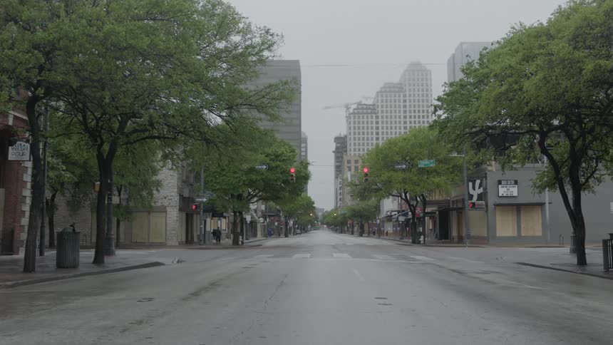 The street is empty on the outskirts of a downtown city