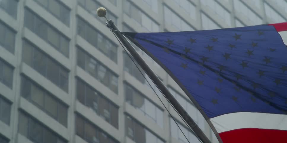 American flag flaps in the wind on the building
