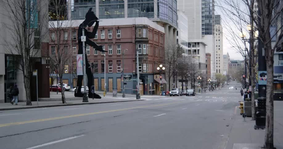 A couple walks down a quiet city street