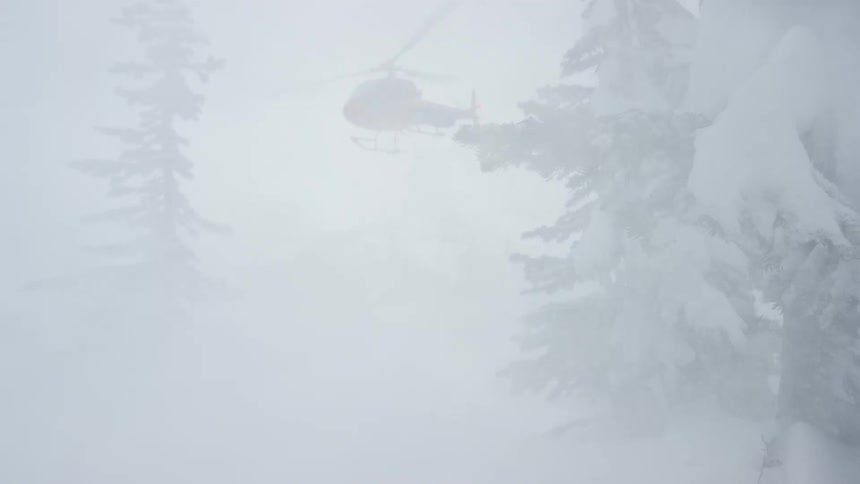 A helicopter flies during a blizzard