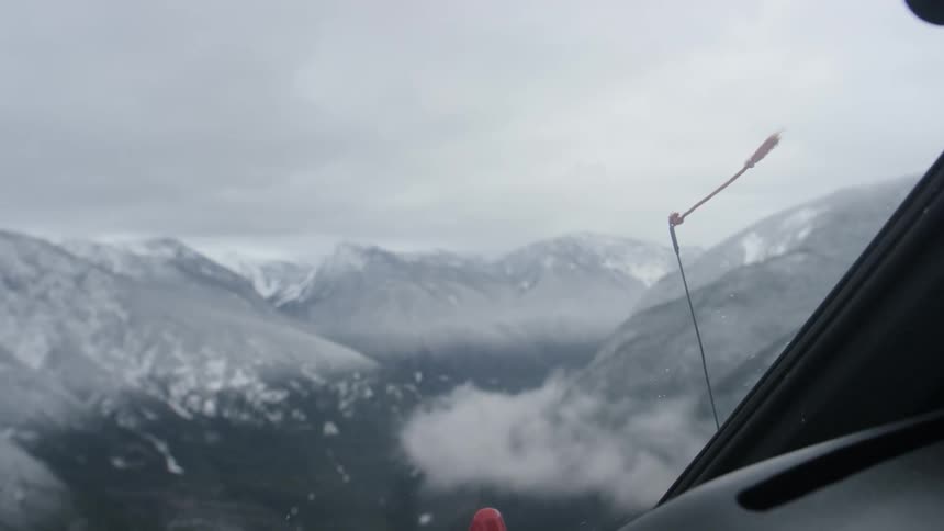 View from helicopter above snow covered mountain range