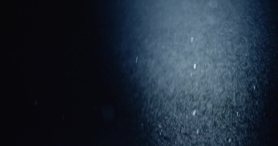 Snow falling in the darkness