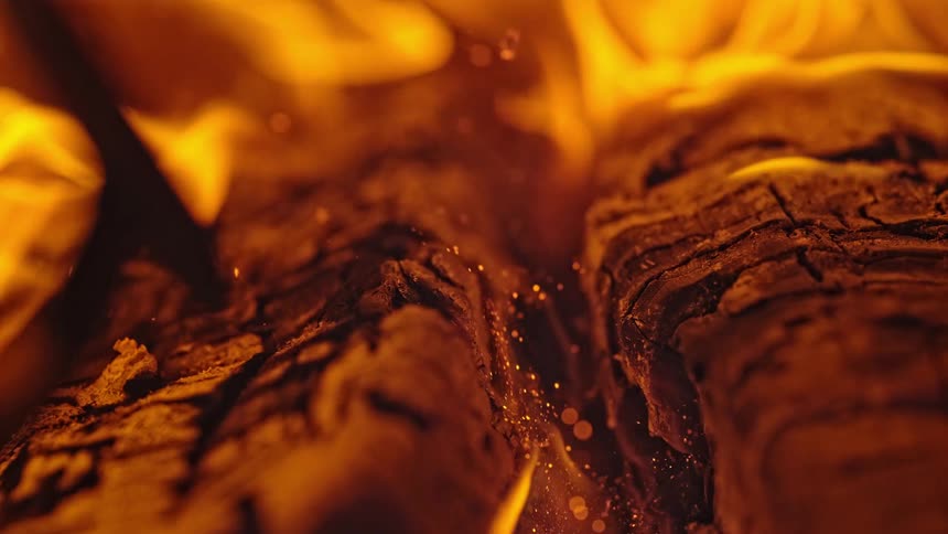 Flames rise from the burning ashes