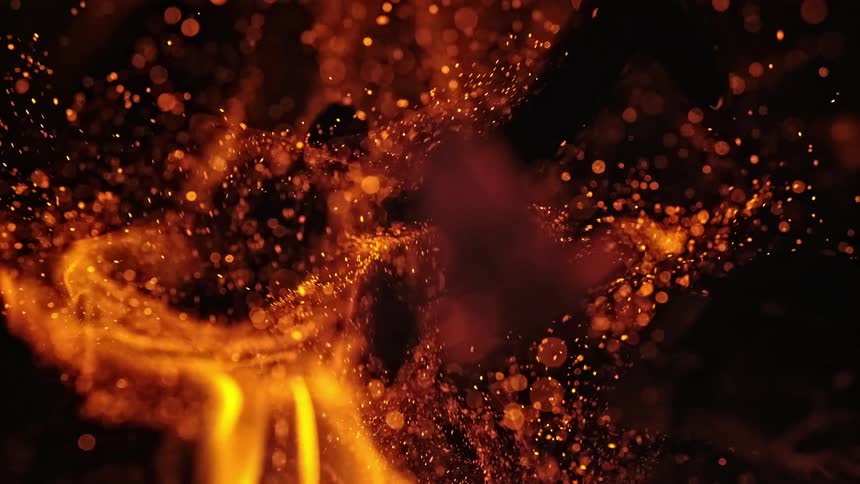 Sparks rise from burning flames