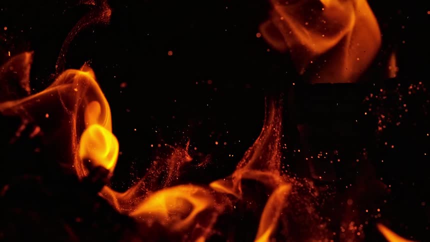 Fire slowly consuming logs on a campfire