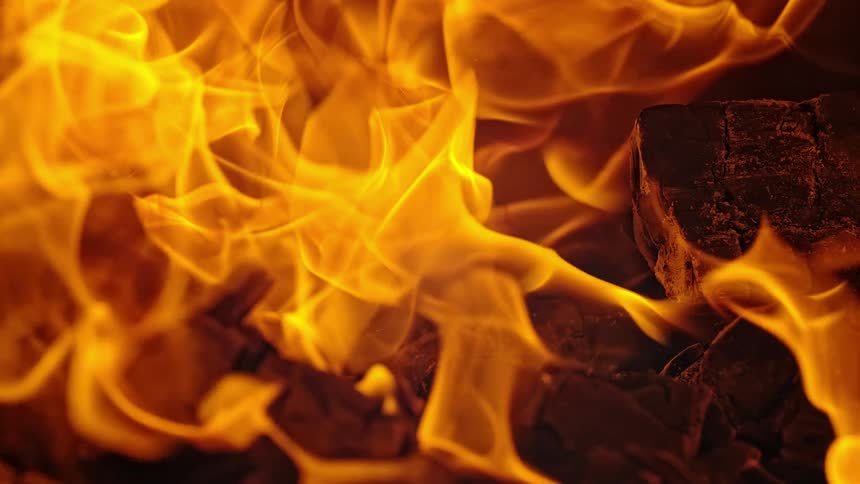 Orange flames consume small blocks of wood