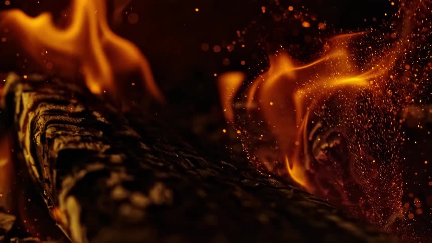 Flames on burning log in the dark