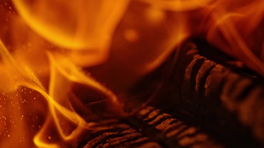 Flames rise from logs