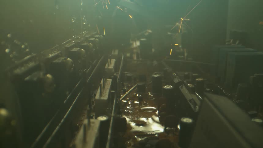 Sparks arc through the air over large machinery