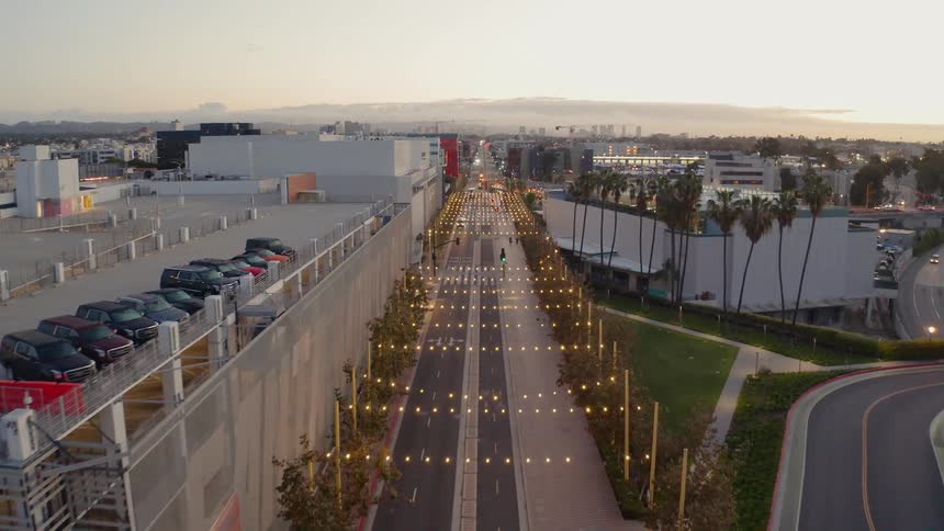 Strings of lights hang over a road in a city