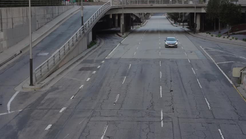 A car drives down an empty highway